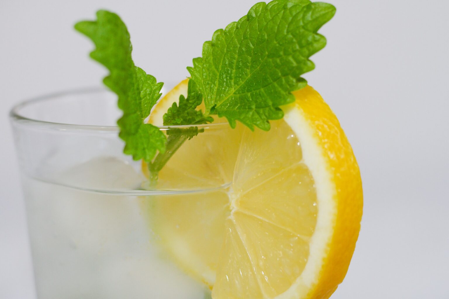 Water glass with lemon and mint delicious refreshing