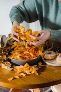 A table full of chips, donuts and other unhealthy foods embodies an unhealthy diet