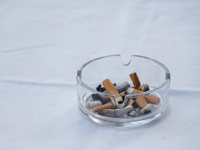 Ashtray with some cigarette butts in it
