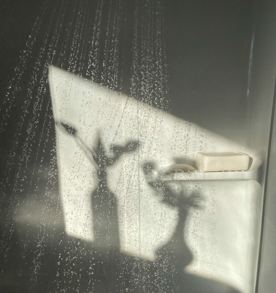 In the shower the water trickles and two washes cast shadows