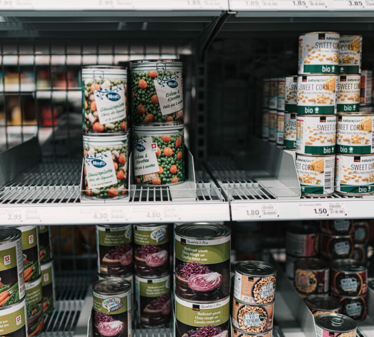 Canned food cans on a supermarket shelf