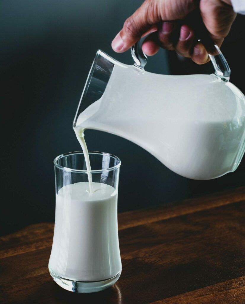 Milch wird in Glas gekippt
