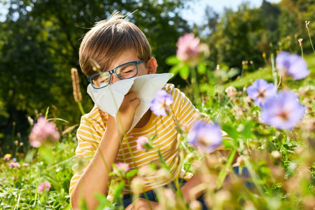 Boy with hay fever in field