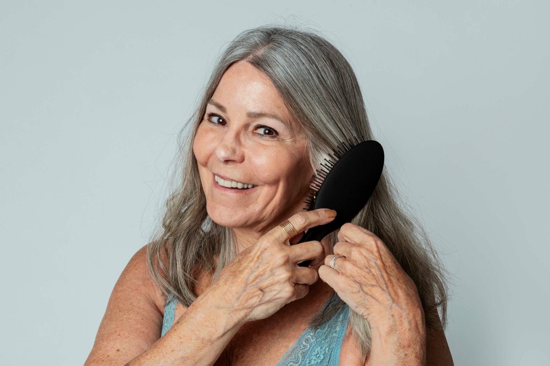 mature woman brushes hair in menopause
