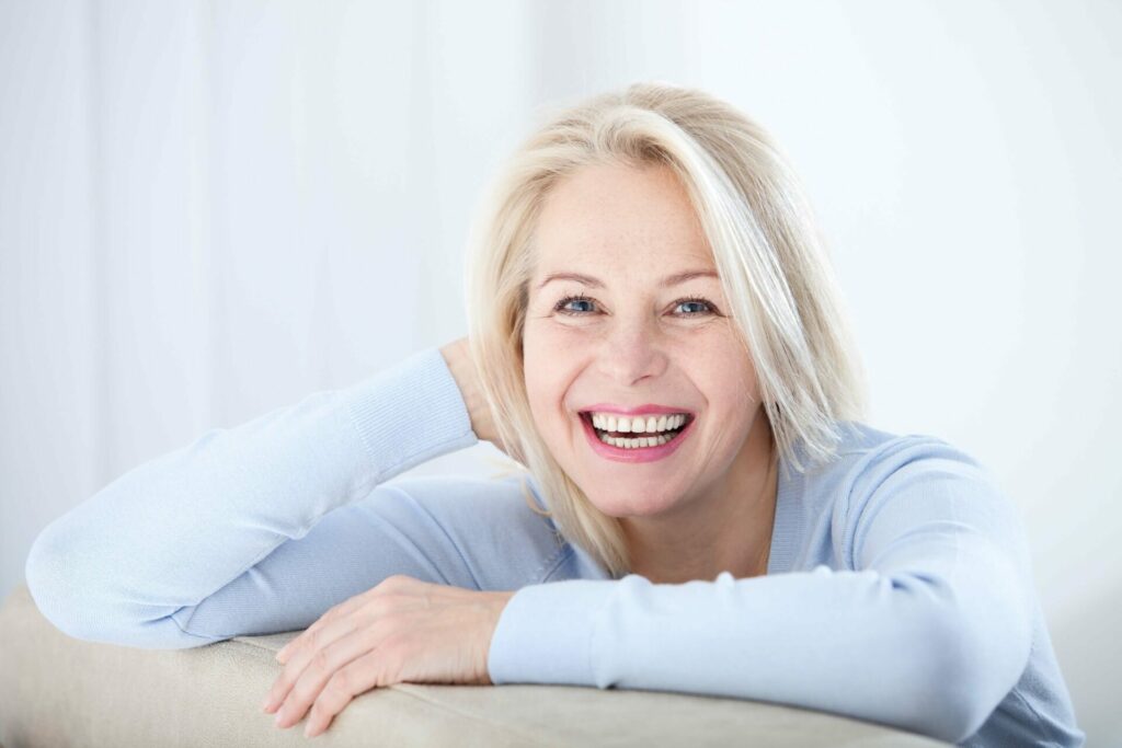 middle aged woman looking happy and satisfied