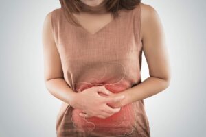Woman holds her aching stomach