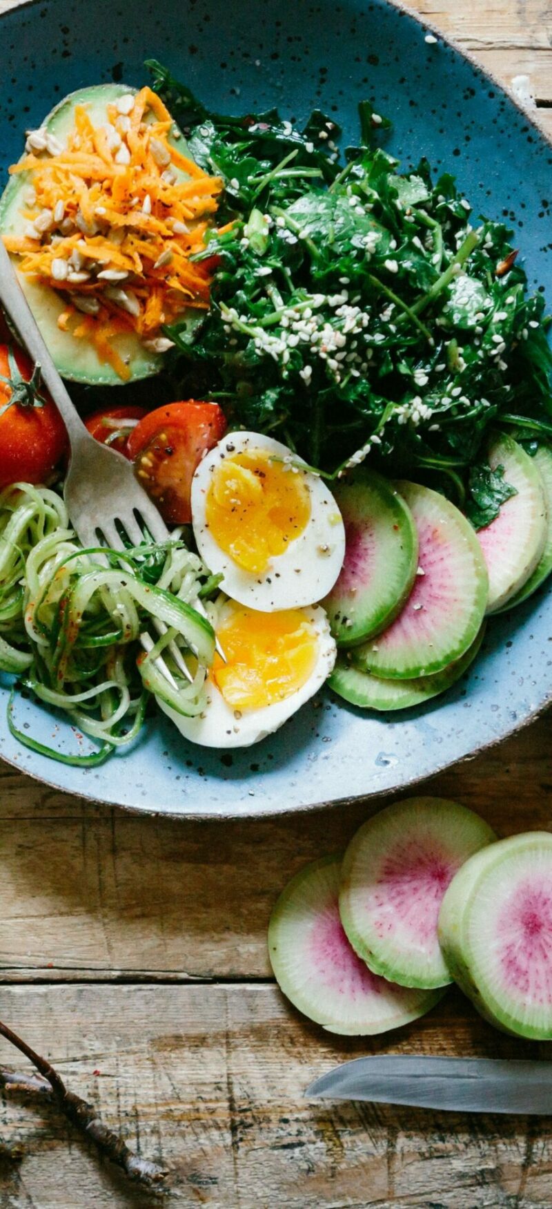 Healthy food, bowl with avocado, tomatoes, eggs and spinach
